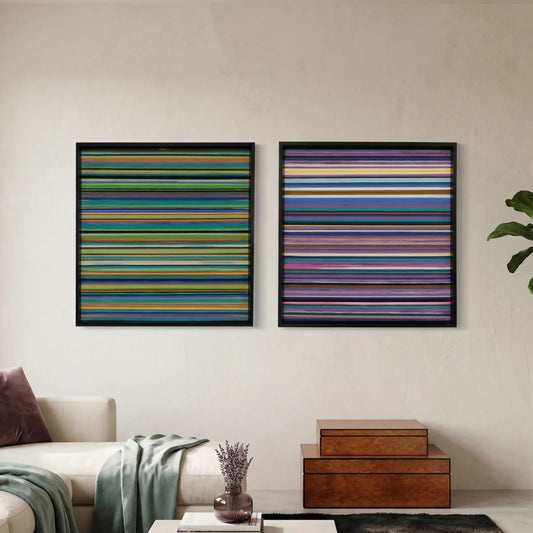 A diptych set of square hand-woven wool wall art featuring fine horizontal stripes in dark jewel tones, greens, and purples, styled in a moody modern living room.