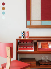 Close-up of Red House yarn wall art revealing tight looped wool stitches and crisp edge transitions between the red panel and turquoise stripes.