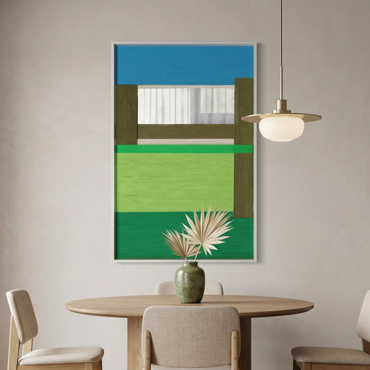 Large vertical hand-woven wool wall art depicting an abstract riverside landscape with blue, green, and moss-tone geometric panels, hanging above an oak dining table with a modern pendant light.