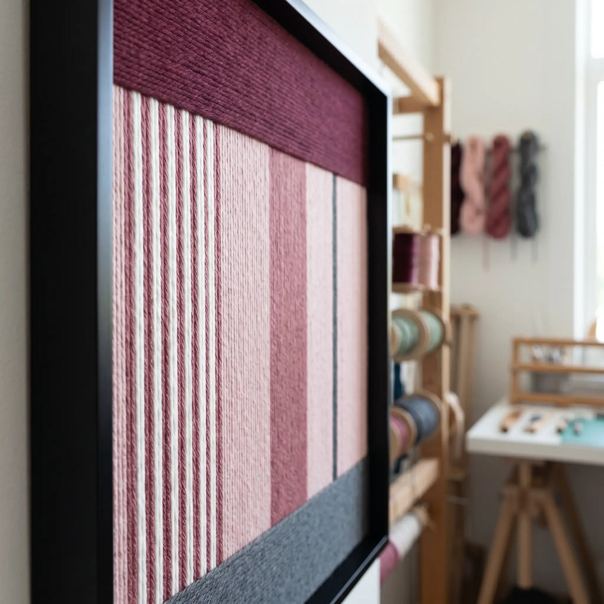 Side view of the framed soft cotton cord wall art in a studio setting showing the depth and three-dimensional texture of the woven fibers.