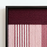 Macro shot of the black metal frame corner highlighting the professional craftsmanship and rich burgundy soft cotton cord fibers of the tapestry.