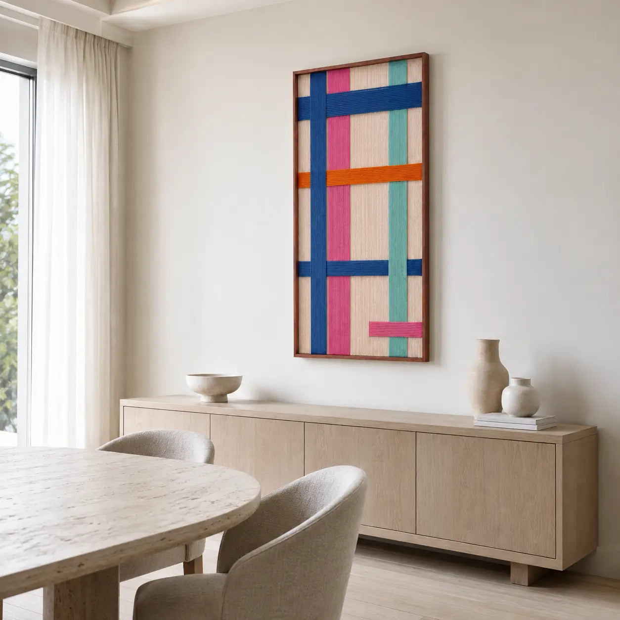 Sophisticated dining room interior showcasing the hand-woven wool tapestry mounted on a textured wall near a wooden dining setup.
