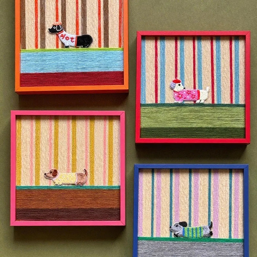 Angled close-up of Scarlet Stripe Pup Saunter showing the looped wool texture and crisp transitions between scarlet, ivory, and sage green stripes.