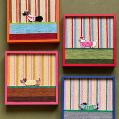 Angled close-up of Scarlet Stripe Pup Saunter showing the looped wool texture and crisp transitions between scarlet, ivory, and sage green stripes.