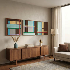 Angled perspective of the Sedona Red Thread three-piece textile wall art hanging above a long dark wood credenza in a modern living space.