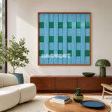 Seine Riverbank blue and green geometric yarn wall art displayed above a wood console in a sunlit modern living room.