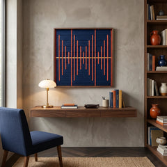 Hand-woven wool wall art with a navy blue base and orange geometric bars displayed above a walnut floating desk in a modern study.