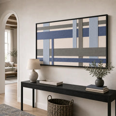 Striking Slate Harbor framed wall art styled in a bright entryway hallway hanging above a sleek black console table.