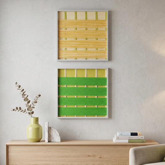 Two stacked hand-woven wool wall art pieces in lime green and lemon yellow hanging above a light wood sideboard in a sunlit room.