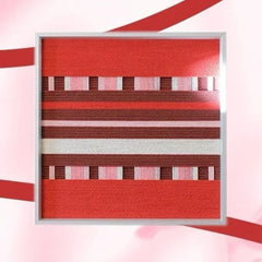 Close-up of Spring Miss yarn wall art revealing tight looped wool texture and crisp transitions between red and burgundy stripe panels.