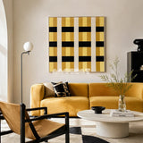 Downton Manor SQ031 mustard gold black and white framed yarn art above a yellow sofa in a bright modern living room