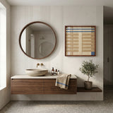 Breathing Shallows SQ105 framed textile art styled above a floating wood vanity in a luxury bathroom.