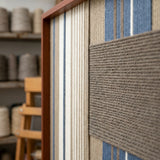 Angled close-up of Coastal Diary SQ122 showing a raised taupe yarn block over blue, white, and beige vertical stripes.