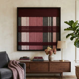 Merlot Veil SQ133 textile wall art displayed above a mid-century wood credenza beside a grey sofa with a mauve throw.