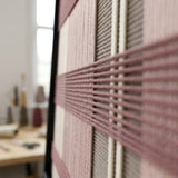 Angled close-up of Nostalgic Bloom SQ136 showing textured dusty rose yarn crossing cream, blush, and taupe stripes.