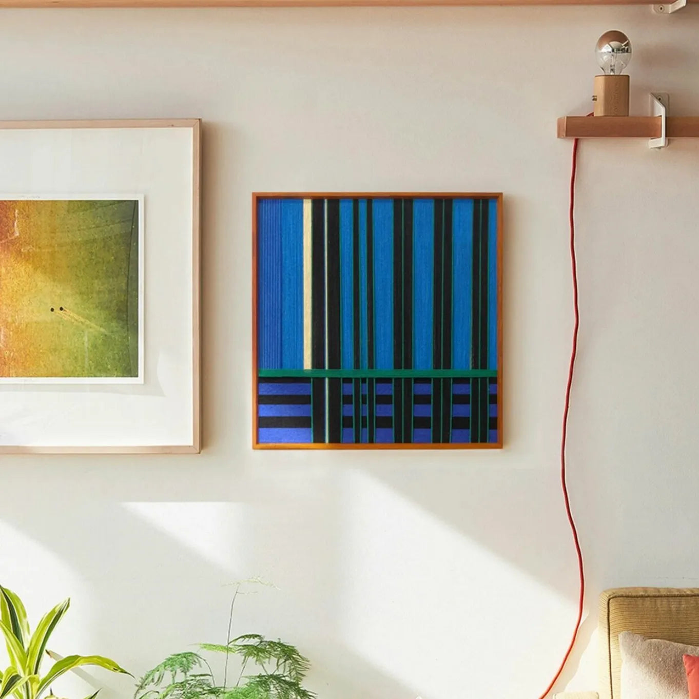 Summer Night’s Serenity wall art hung above a sofa, emphasizing its square format, deep-color stripes, and modern organic feel