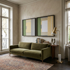 Set of two framed Sun-Baked hand-woven textile artworks hanging elegantly above an olive green sofa in a sunlit, modern living room.