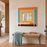 Sun-Drenched Days colorful yarn-framed mirror displayed above a woven bench in a bright modern entryway.