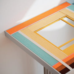 Angled close‑up of Sun‑Drenched Days yarn wall art showing the looped wool texture and crisp transitions between peach, yellow, and blue stripes.