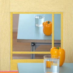 Sun‑Drenched Days yarn wall art resting on a tabletop next to a pastel vase and fruit bowl, emphasizing its versatile display options.