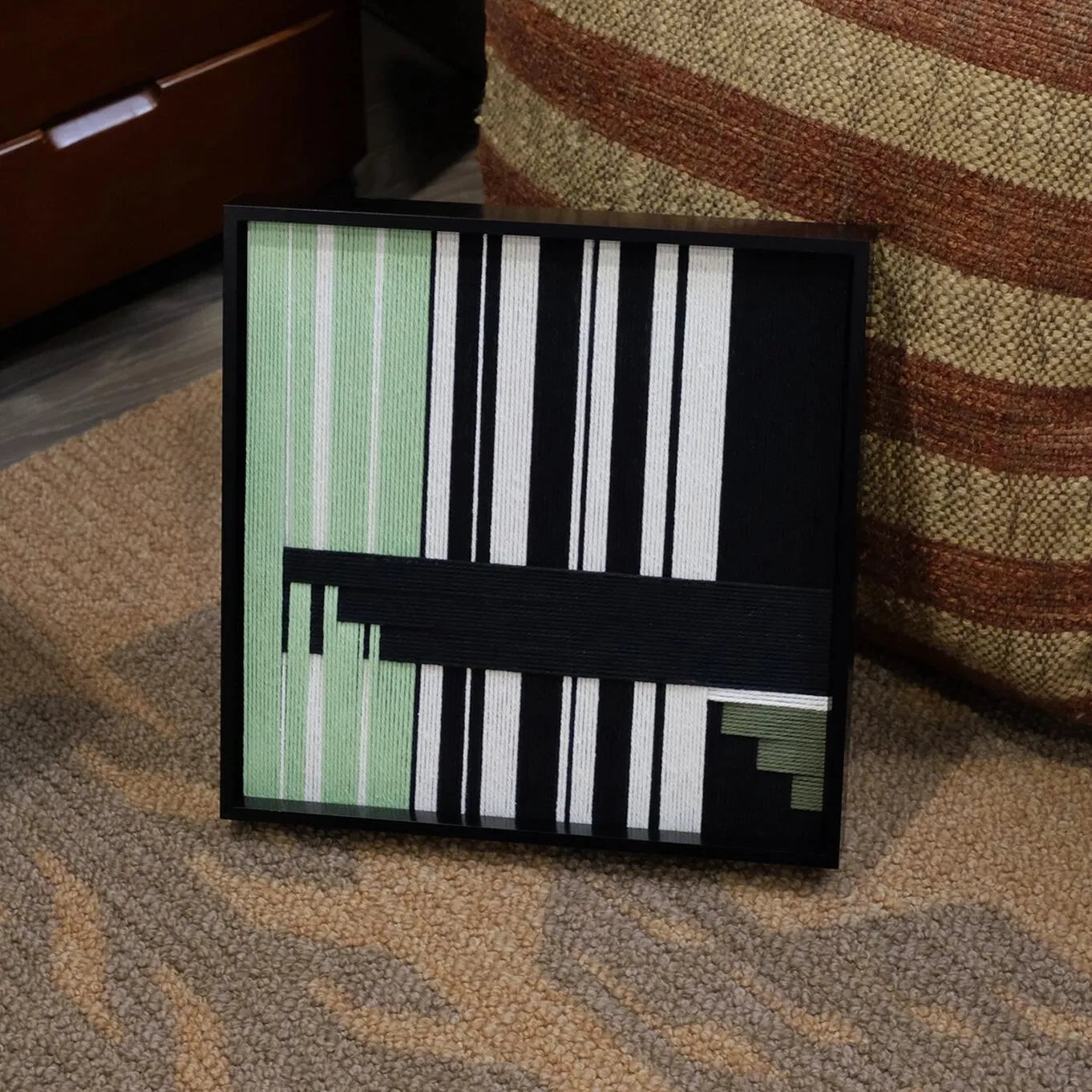 Front view of the left panel of Timeless Moments diptych on a plain white background, highlighting its emerald and black stripe composition.