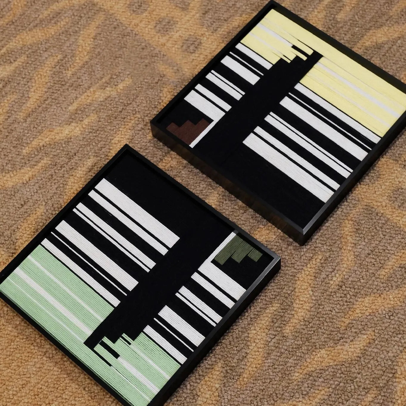 Timeless Moments yarn diptych resting on a stone ledge outdoors, highlighting its vivid stripe blocks and durable wool texture.