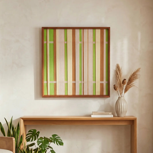 Square hand-woven wool wall art featuring vertical stripes in lime green, beige, and tan tones hanging above a minimalist wooden console table.