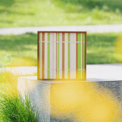 Tree Ah Tree wall art displayed outdoors with blurred yellow flowers in foreground