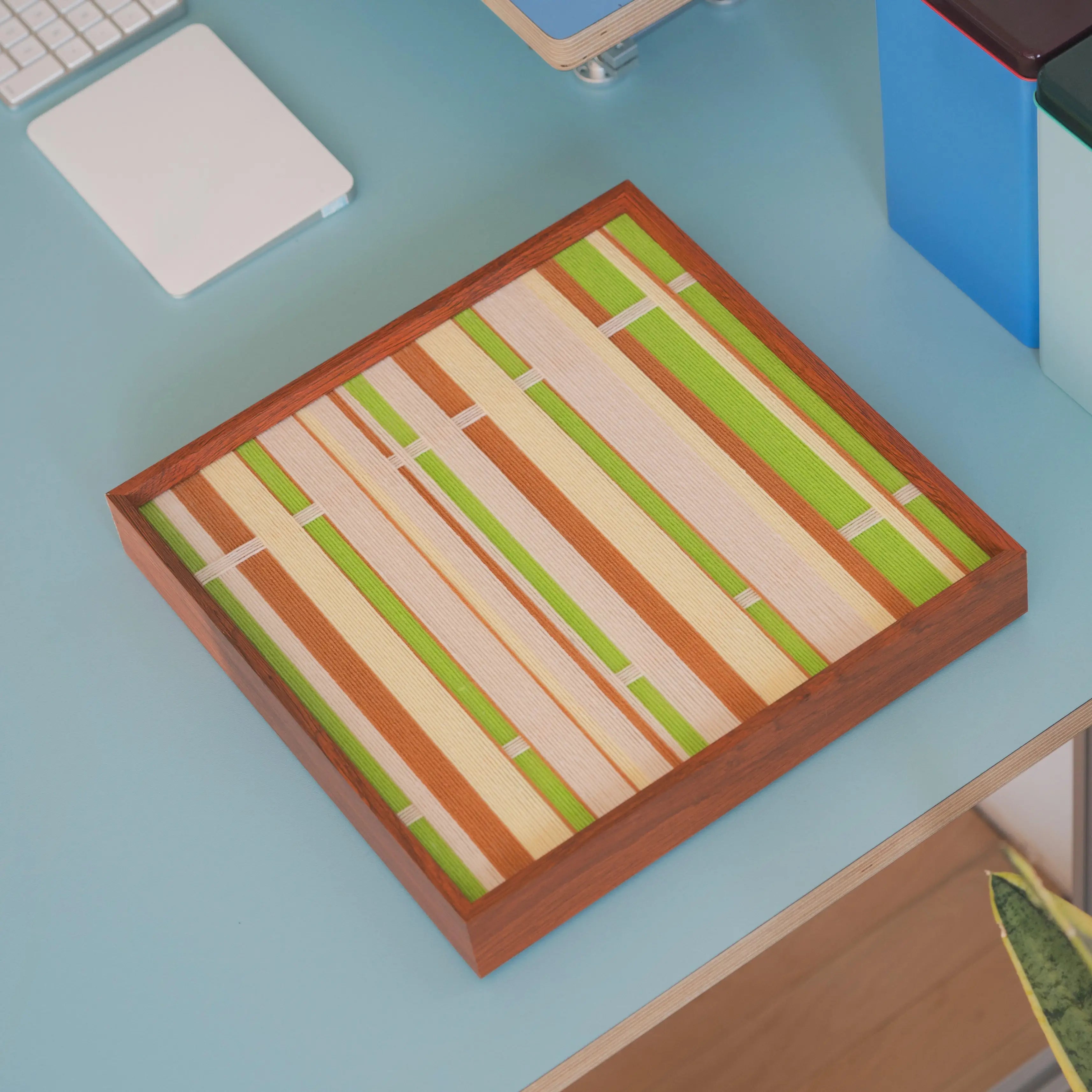 Overhead close-up of Tree Ah Tree yarn woven wall art showcasing texture and wood frame