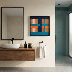 Large square hand-woven wool wall art in teal, navy, and orange displayed in a modern luxury bathroom above a floating walnut vanity.