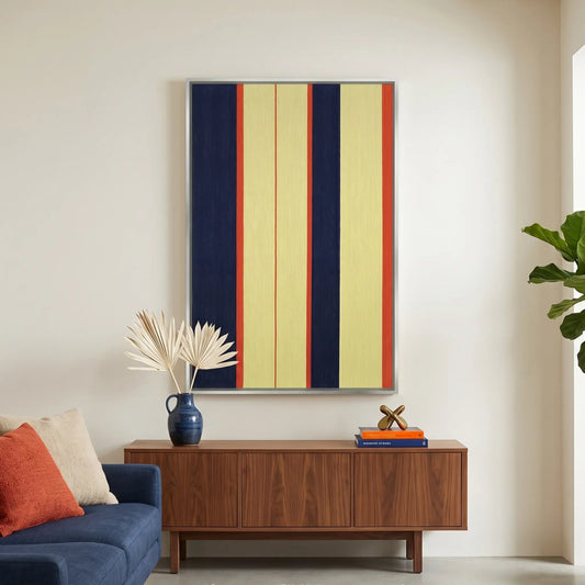Large vertical hand-woven wool wall art with navy blue, yellow, and red stripes hanging above a walnut credenza in a modern living room.
