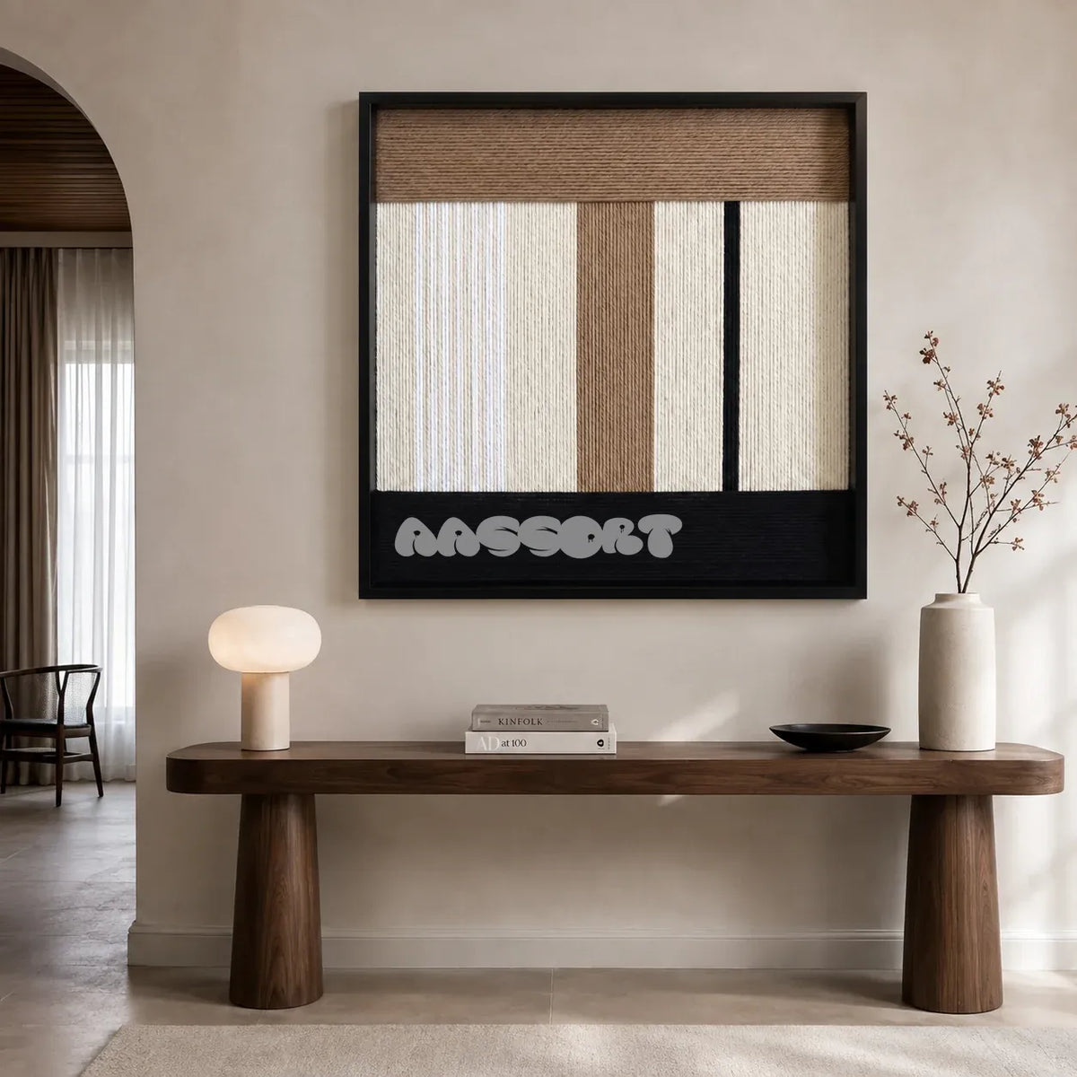 Undisturbed Snow cream taupe and black textile wall art displayed above a sculptural walnut console in a calm modern entryway.