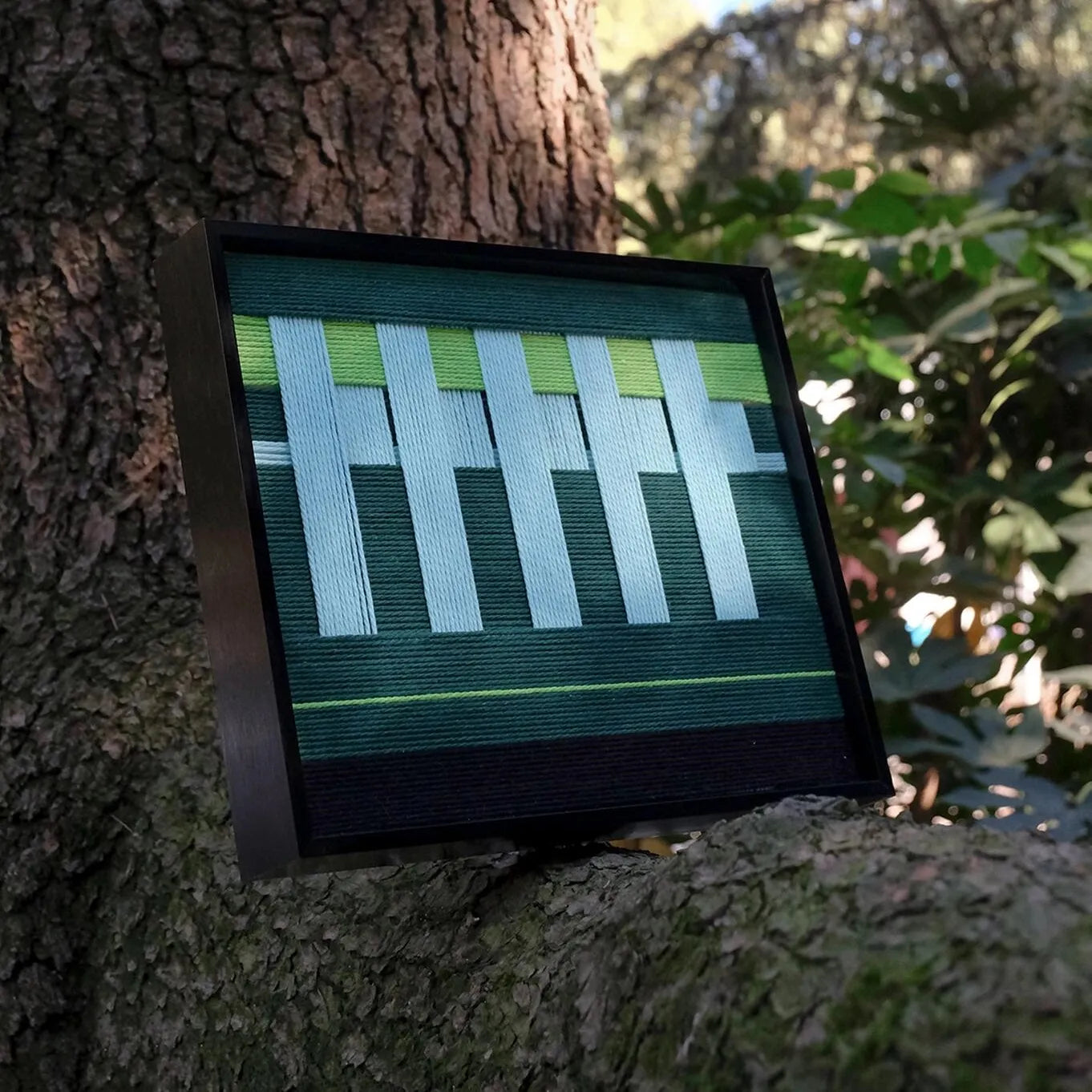 Detailed close-up of Velvet Vine yarn wall art showing looped wool texture and vibrant lime green stripe fibers