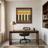 Square textured textile art piece centered above a dark wood desk in a professional home office setting with a gold table lamp.