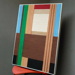 Angled close-up of Wild yarn wall art highlighting tight stitch detail of premium wool and crisp transitions between earth-stripe colors