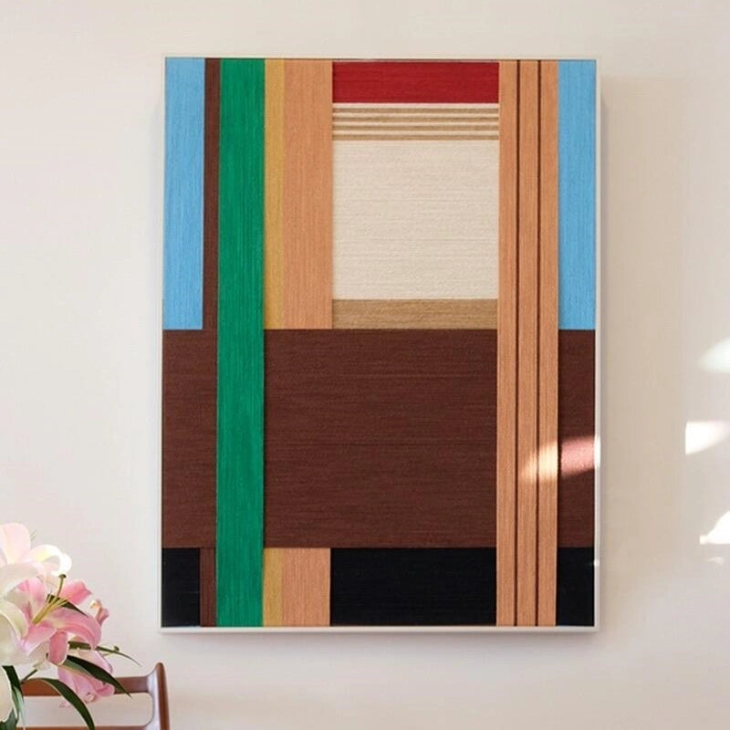 Wild hand-woven wool yarn wall art in square format, featuring alternating wide stripes of chocolate brown, sandy beige, and olive green in a natural wood frame