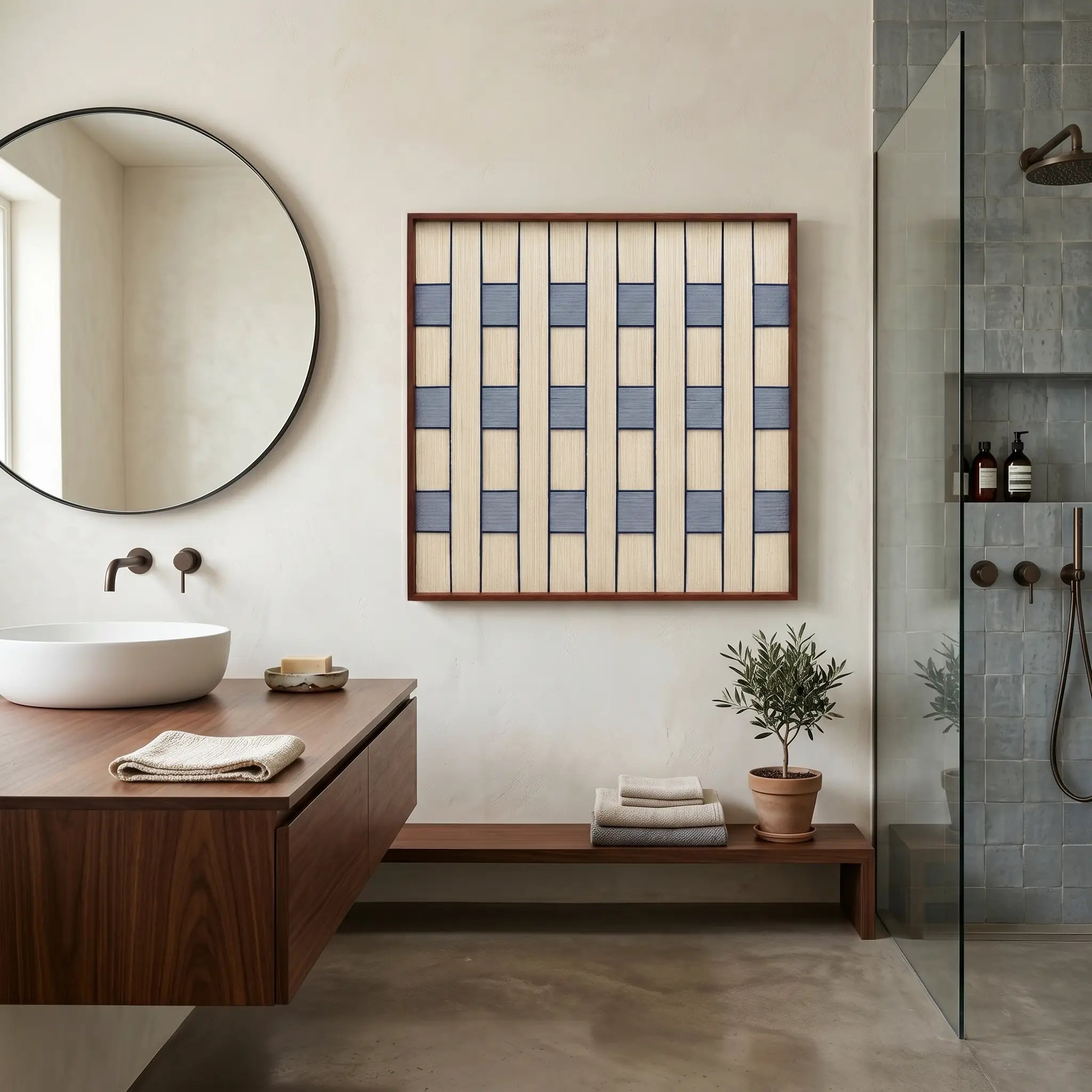 Large square hand-woven wool wall art with blue and cream checkered patterns displayed in a modern luxury bathroom above a walnut floating vanity.