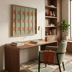 Handmade wool wall decor in a wooden frame placed next to a bookshelf with ceramics in a contemporary study room.