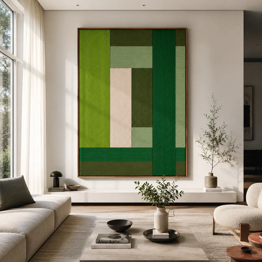 Evergreen Harmony framed fiber wall art with lime, forest green, sage and cream geometric blocks in a bright modern living room