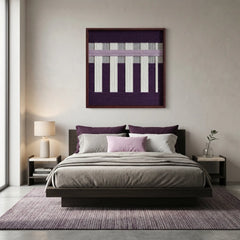 Large-scale textured fiber wall art hanging above a bed with purple accents, creating a cohesive and calming modern bedroom aesthetic.