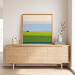 Modern credenza setup displaying the square hand-woven wool tapestry against a neutral wall with decorative vases.