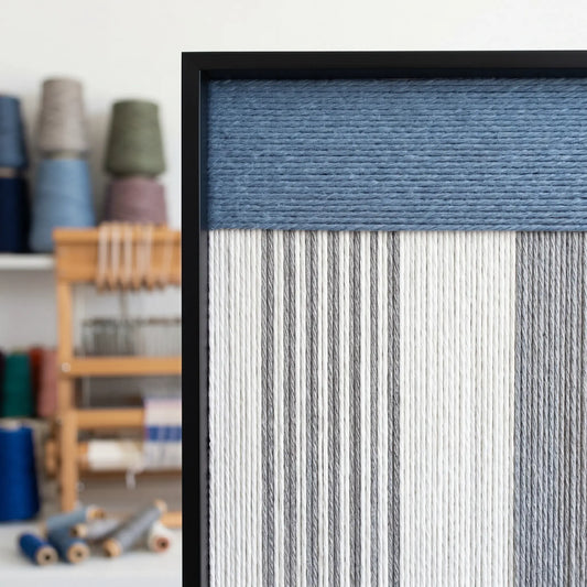 Close-up of the hand-woven wool texture and black frame corner, highlighting the high-quality blue and white yarn craftsmanship.