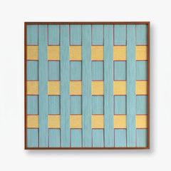 Frontal studio shot of the Afternoon Window hand-woven textile wall art featuring light blue and yellow geometric patterns in a wooden frame against a clean white background.