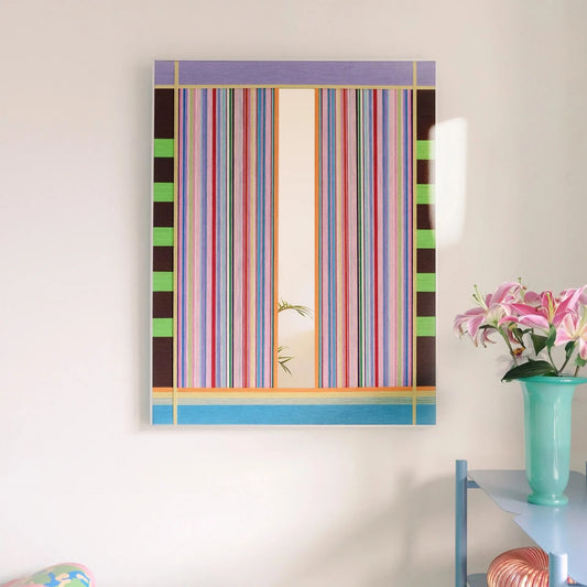 Blooming Flowers hand-woven wool yarn wall art featuring alternating pastel pink, coral, mint, and sky-blue vertical stripes in a natural wood frame, displayed above a console table with vase and books.

