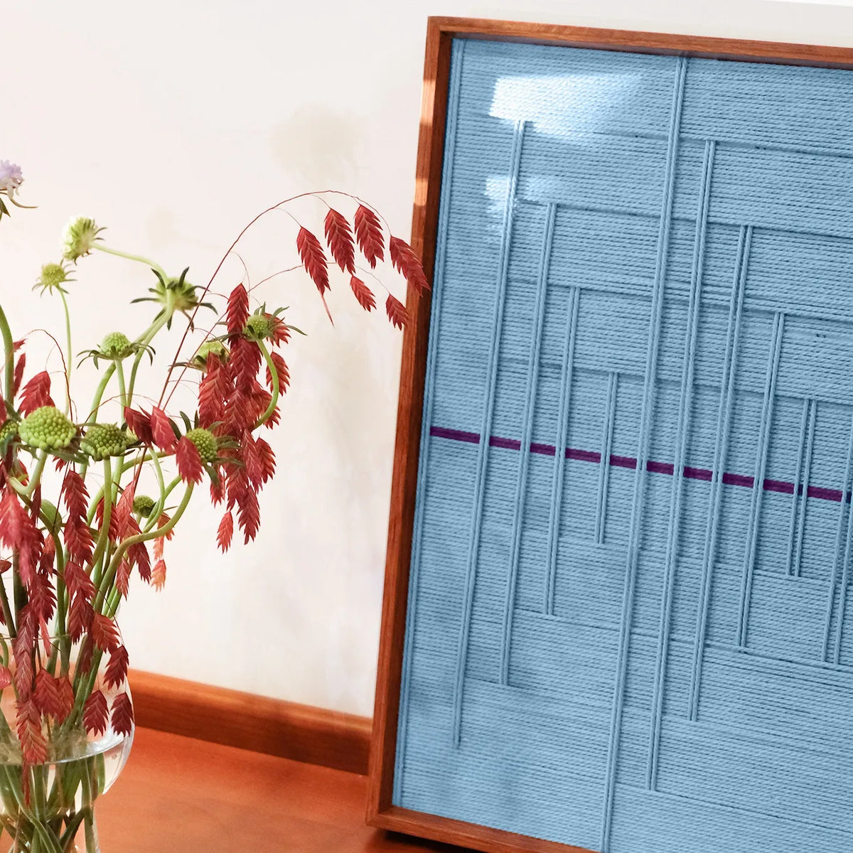 Angled view of Blue Bridge Over the Pond yarn wall art emphasizing the textured surface and crisp transitions between grid and panel areas
