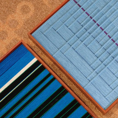 Blue Bridge Over the Pond yarn wall art displayed on a shelf with minimal décor, highlighting the grid panel and solid blue section contrast
