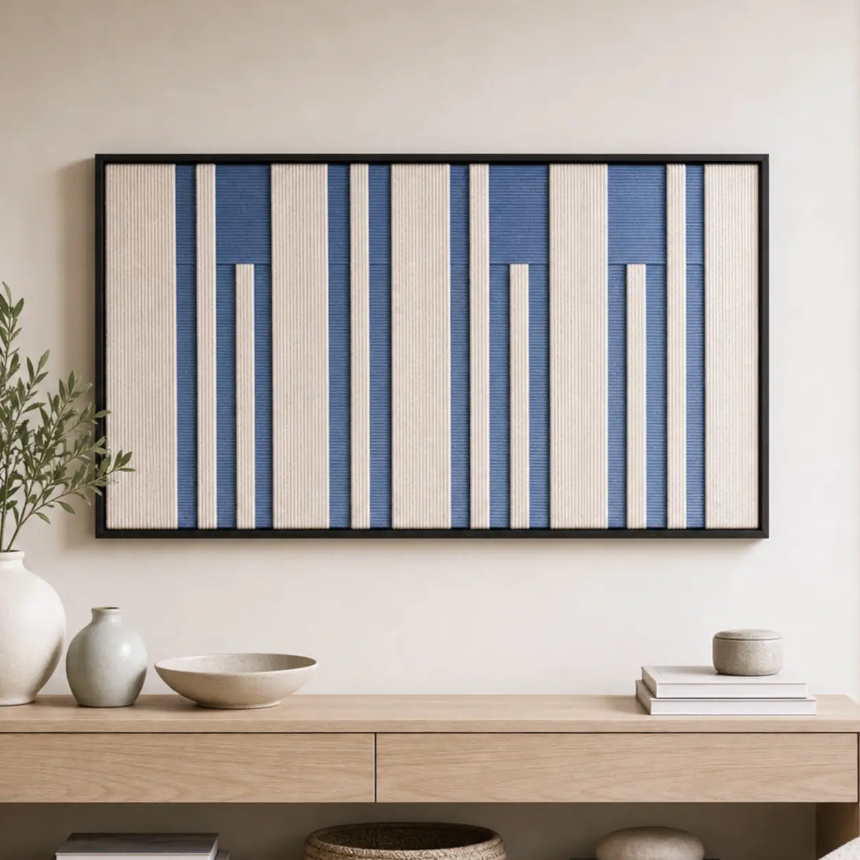 The Blue Cadence hand-woven wool tapestry styled above a minimalist light wood console table with decorative ceramics.