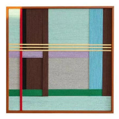 Front view of the third variation featuring grey, blue, and brown woven blocks, highlighting the high-quality craftsmanship of the fiber art.