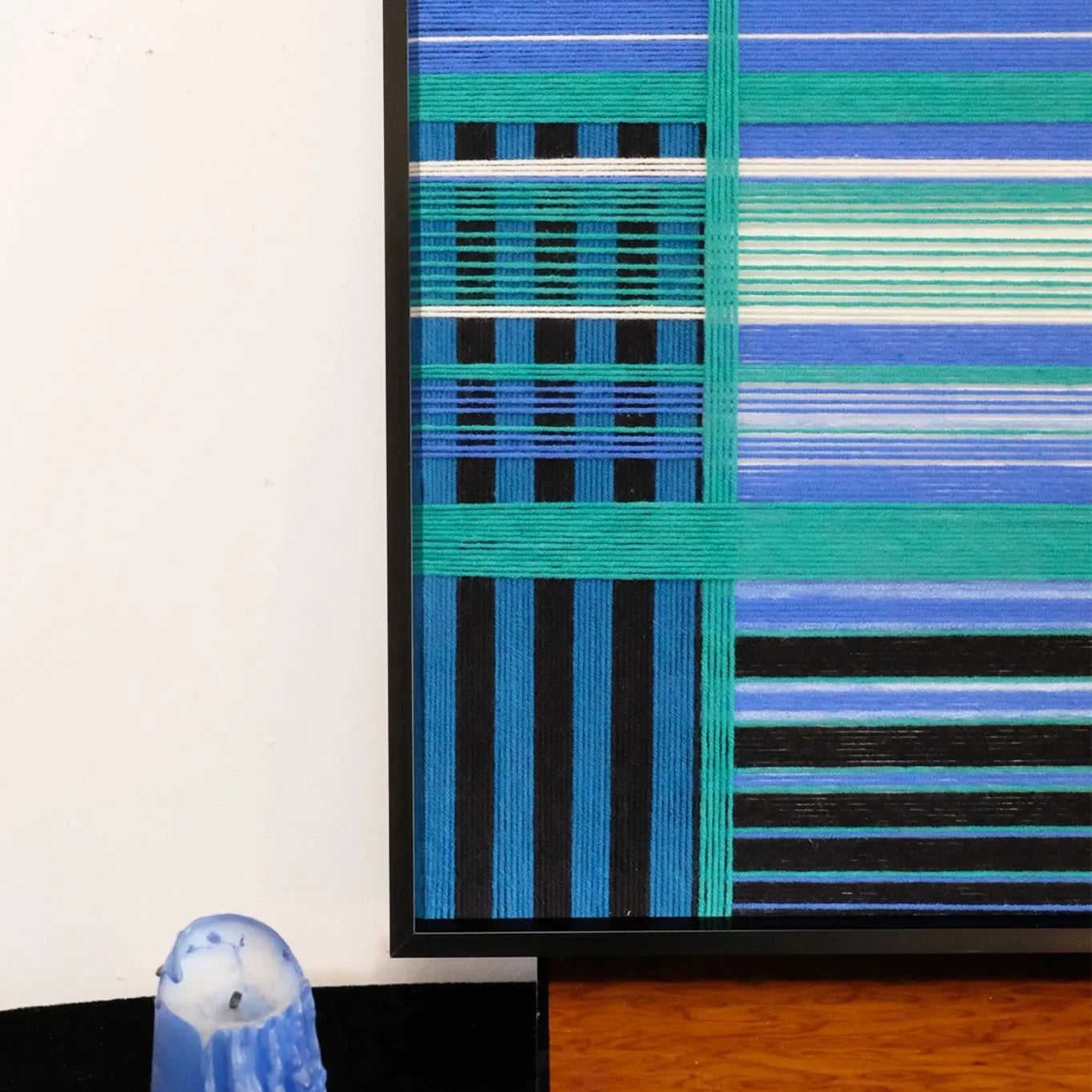 Close-up of Blues Harmony yarn art revealing tight looped wool texture and crisp transitions between navy and sky blue stripes
