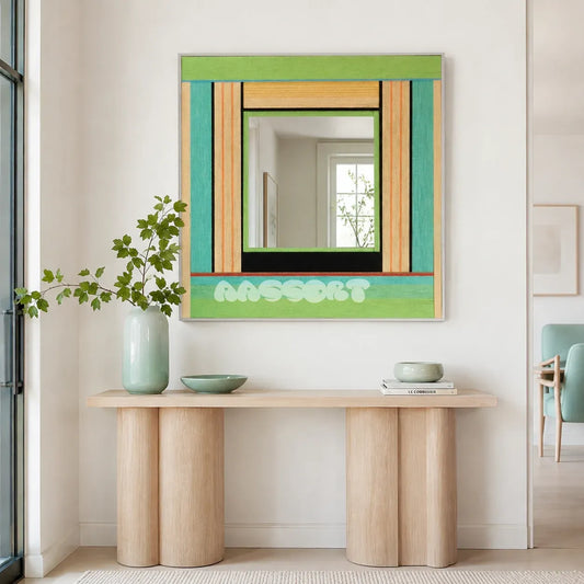 Breathing Like Fresh Grass green, aqua, tan, and black yarn-framed mirror displayed above a pale wood console in a bright entryway.